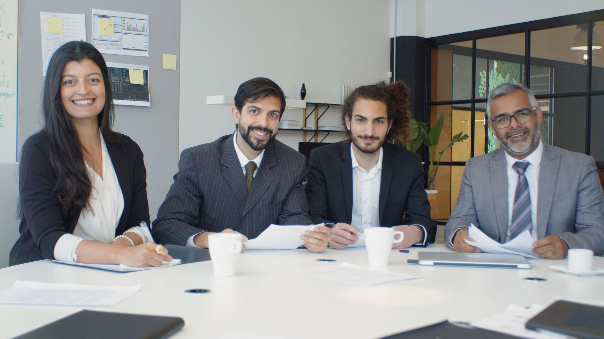 Accounting and real estate professionals reviewing commercial property documents  at a table