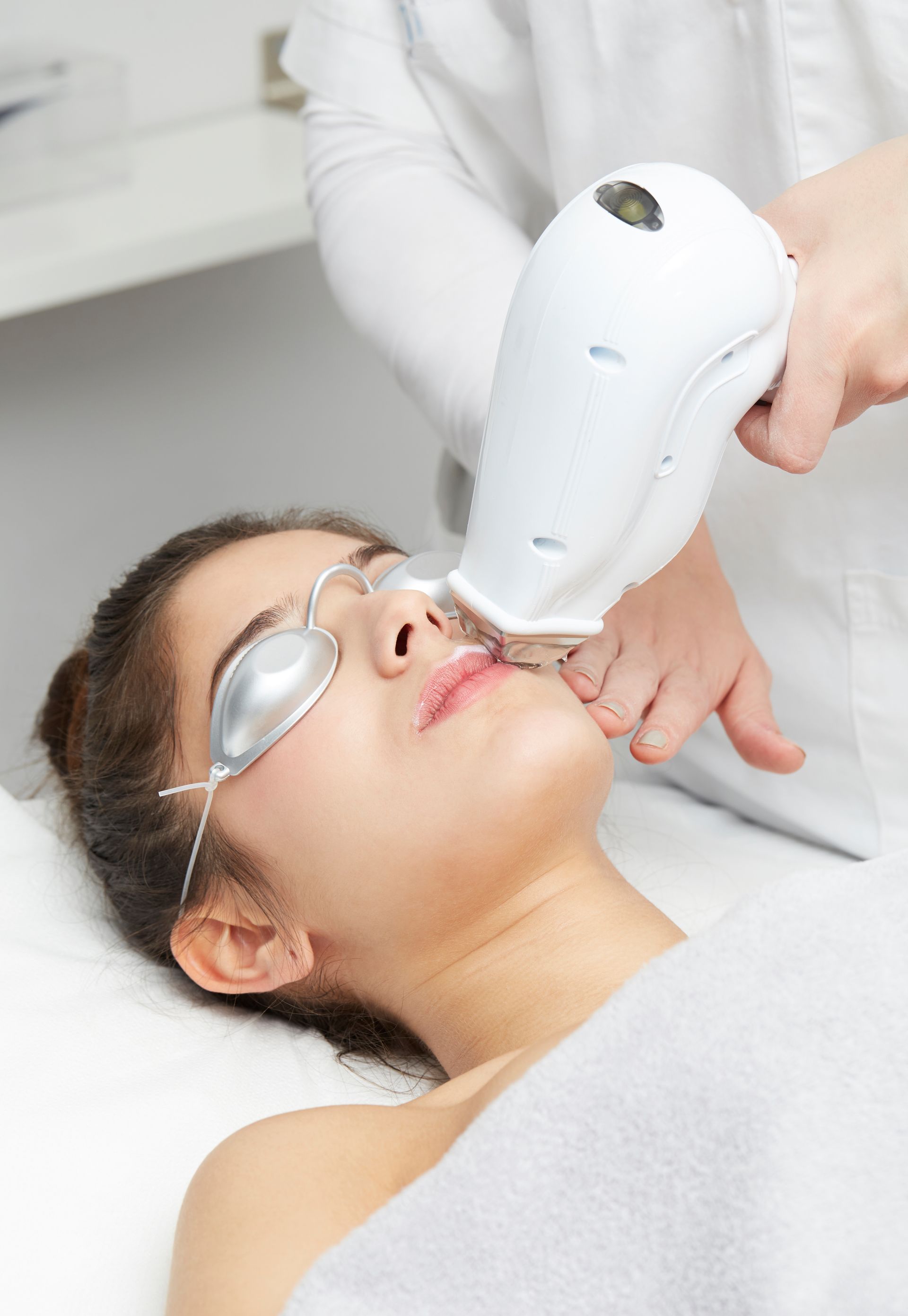 a woman is getting a laser treatment on her face .