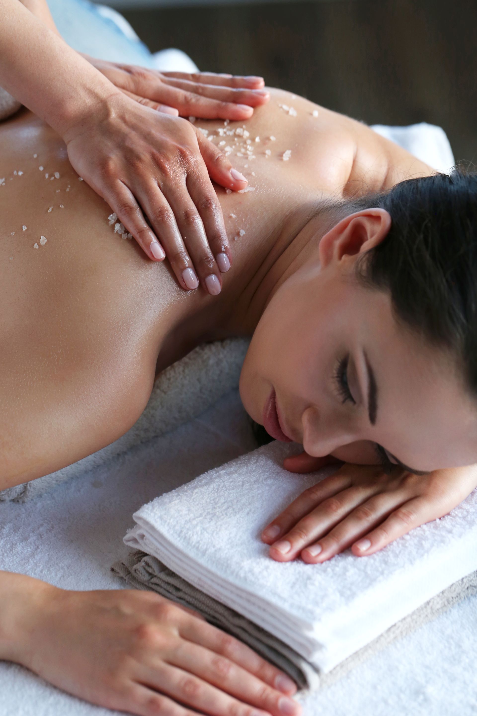 a woman is laying on a table getting a massage