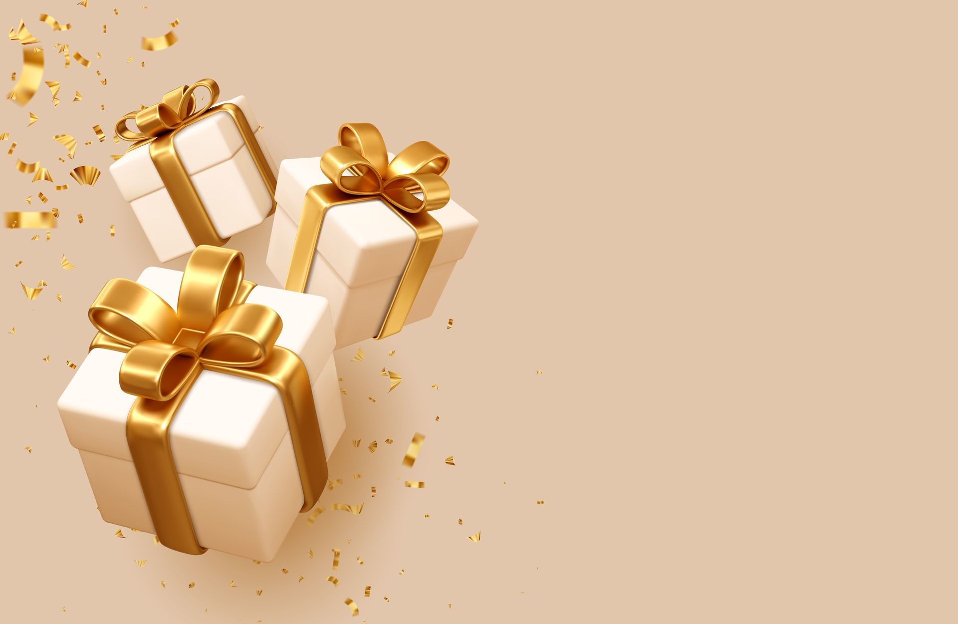 Three white gift boxes with gold ribbons and bows on a beige background.