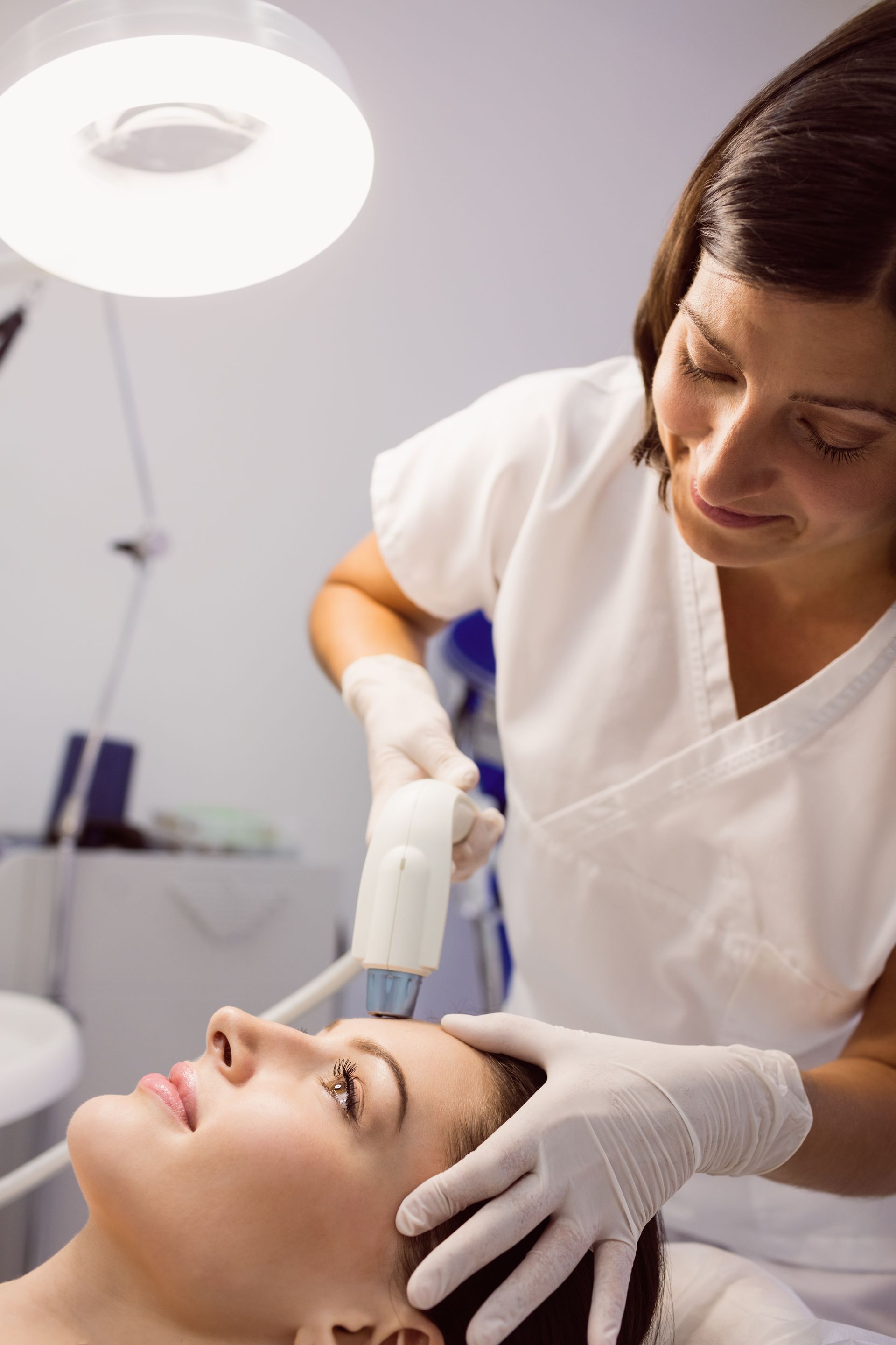 a woman is getting a facial treatment at a beauty salon .