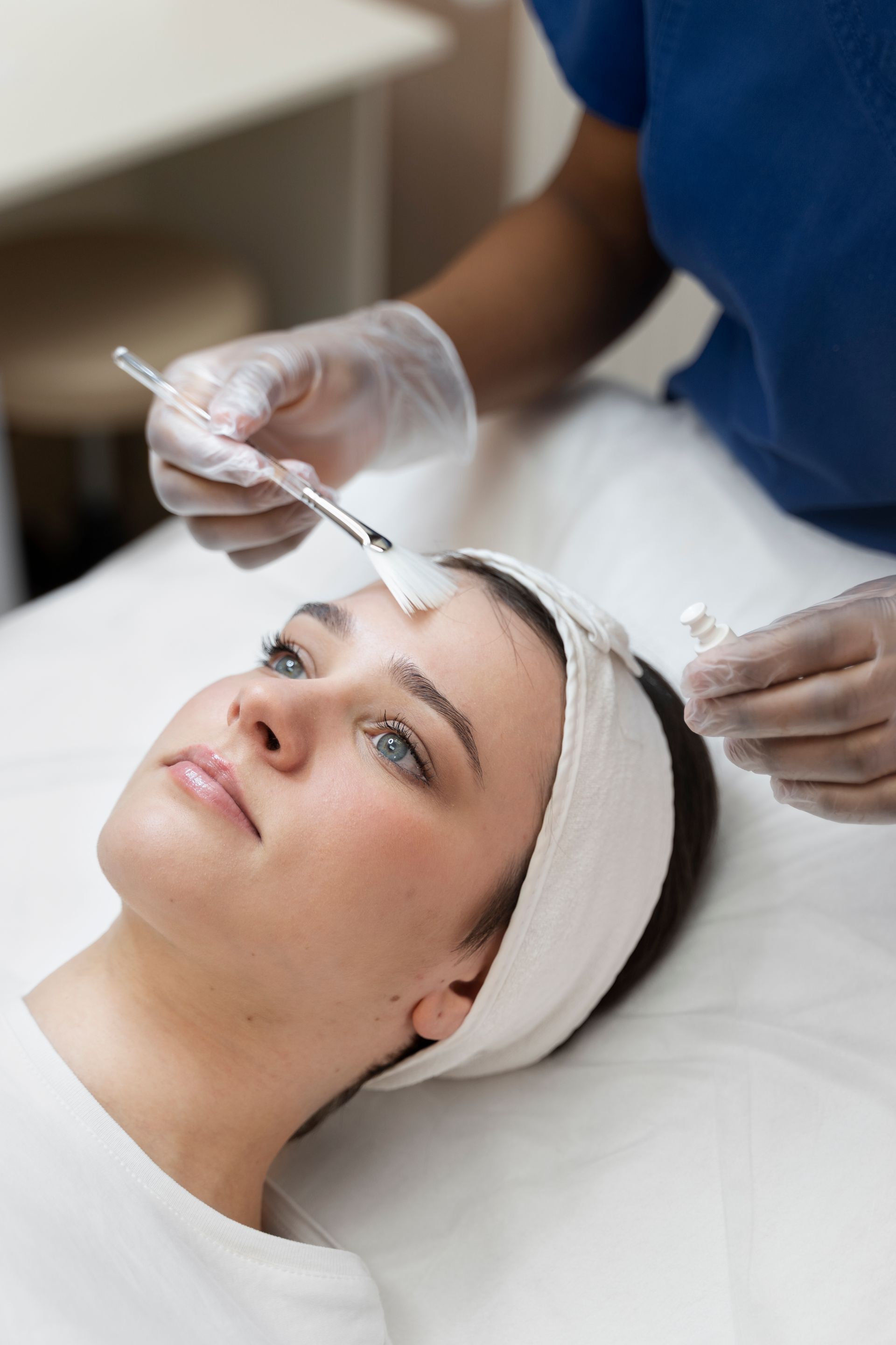 a woman is getting a facial treatment at a beauty salon .