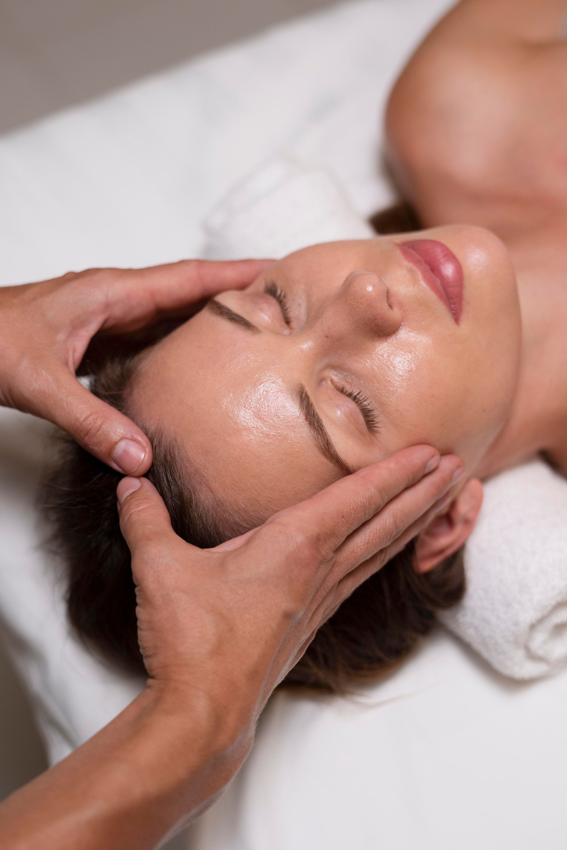 a woman is getting a head massage at a spa .