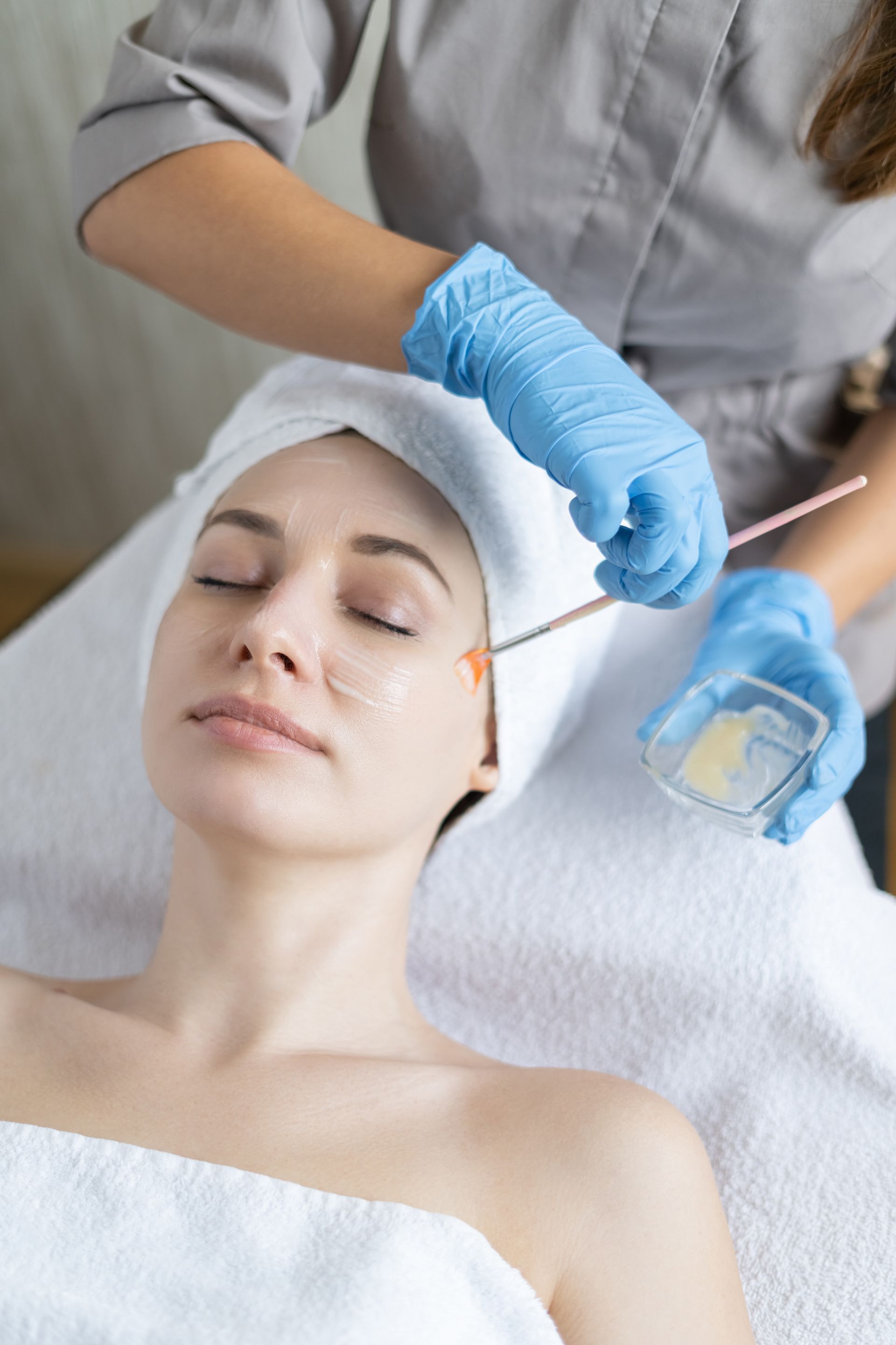 a woman is getting a facial treatment at a spa .