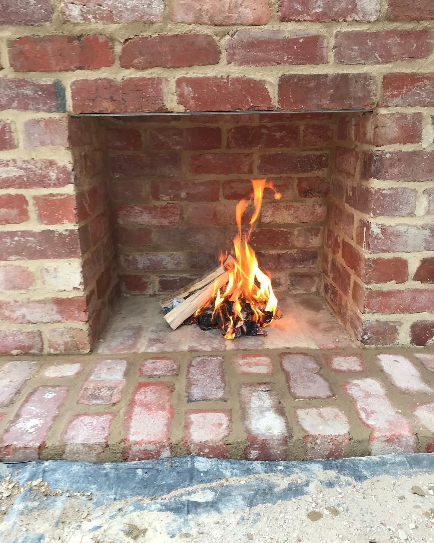 outdoor brick fireplace fire