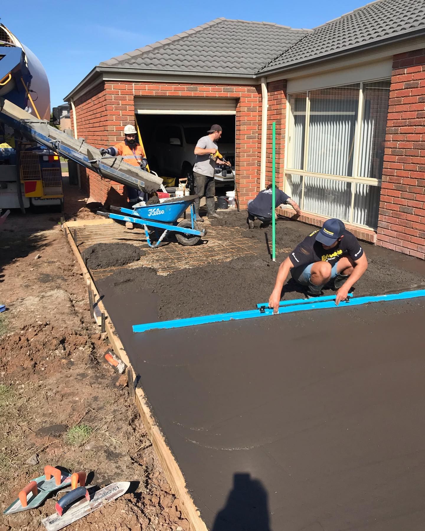 charcoal coloured concrete slab being poured and screeded in Cowes, Phillip Island.