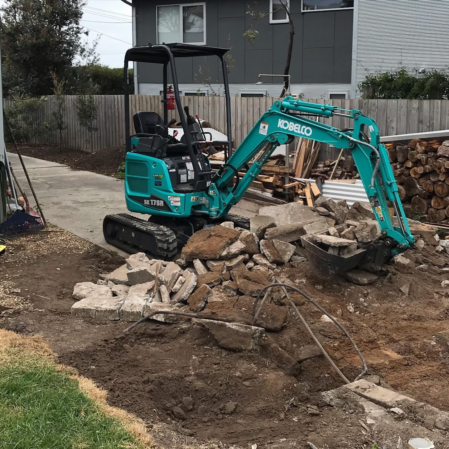 excavator ripping up concrete