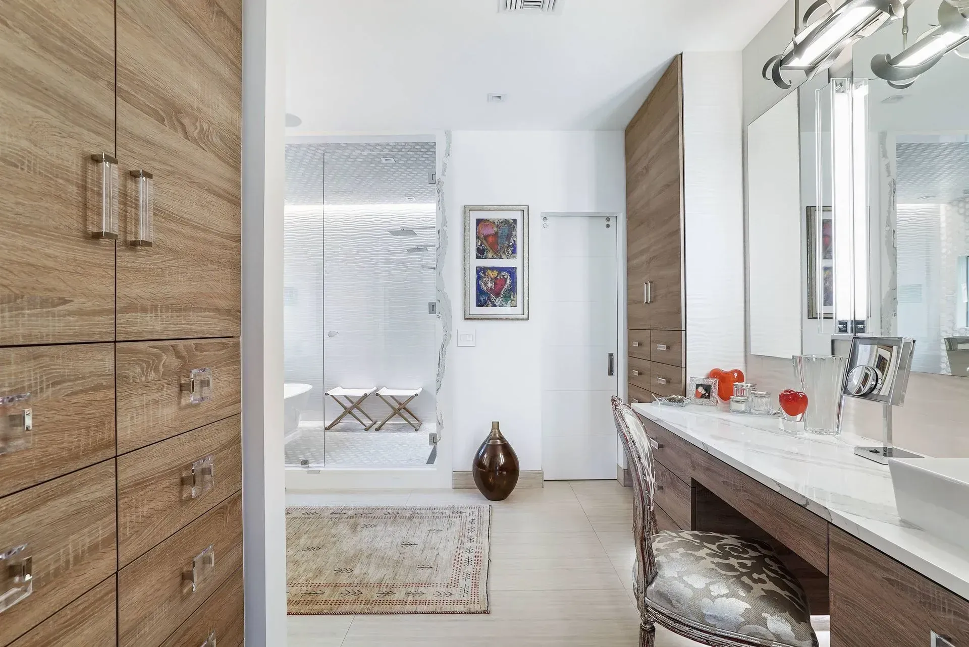 Bright modern bathroom with wooden cabinets, white vanity, mirror, and glass shower area
