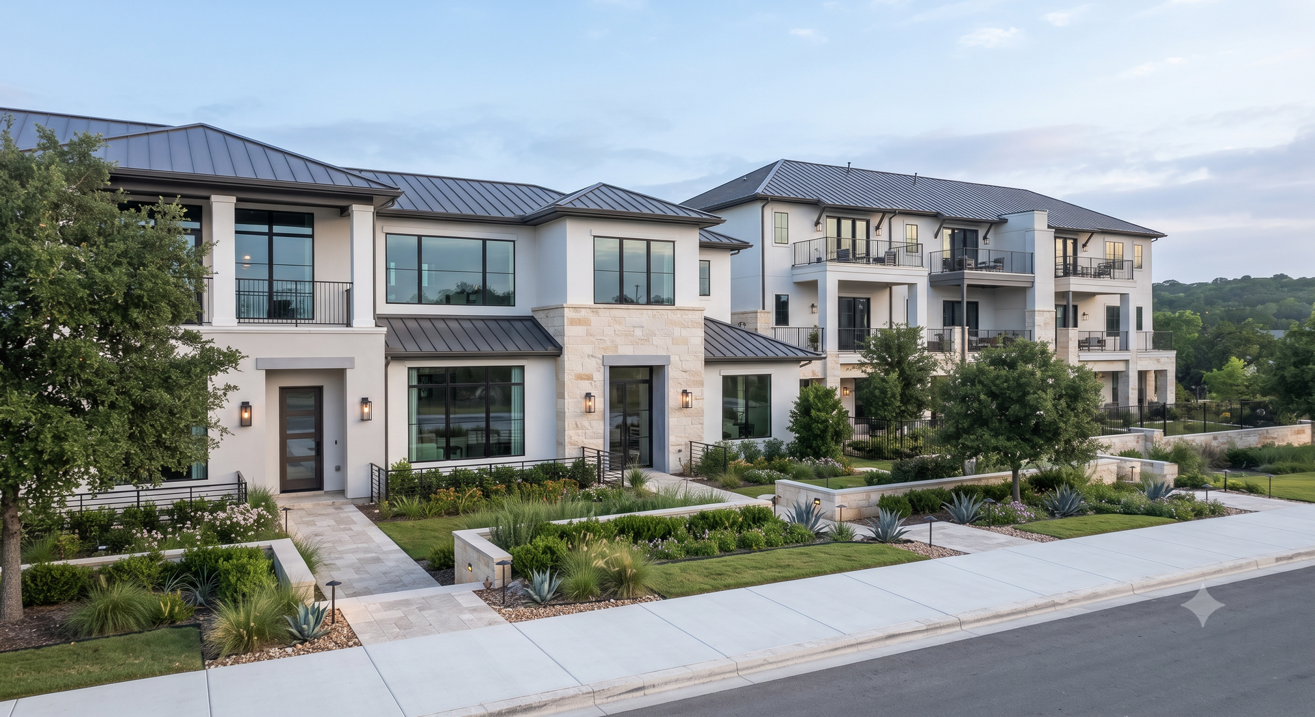 Modern suburban townhomes with landscaped front yards along a quiet street.