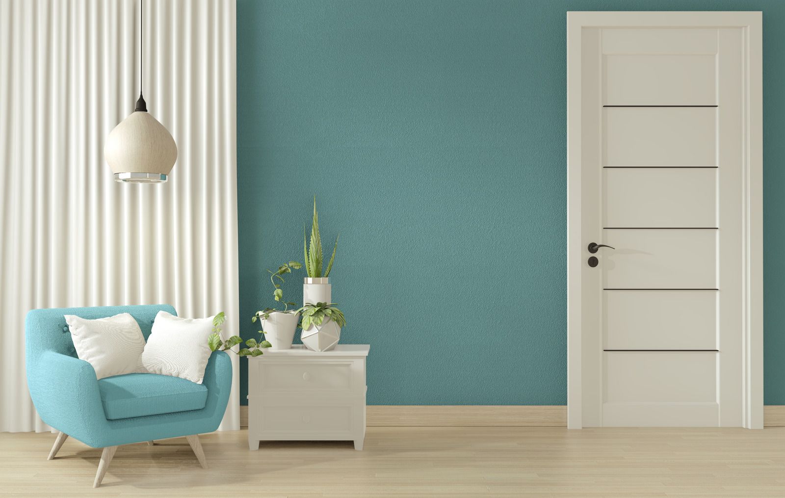 Minimalist living room with teal chair, white cabinet, hanging lamp, and teal accent wall beside a white door