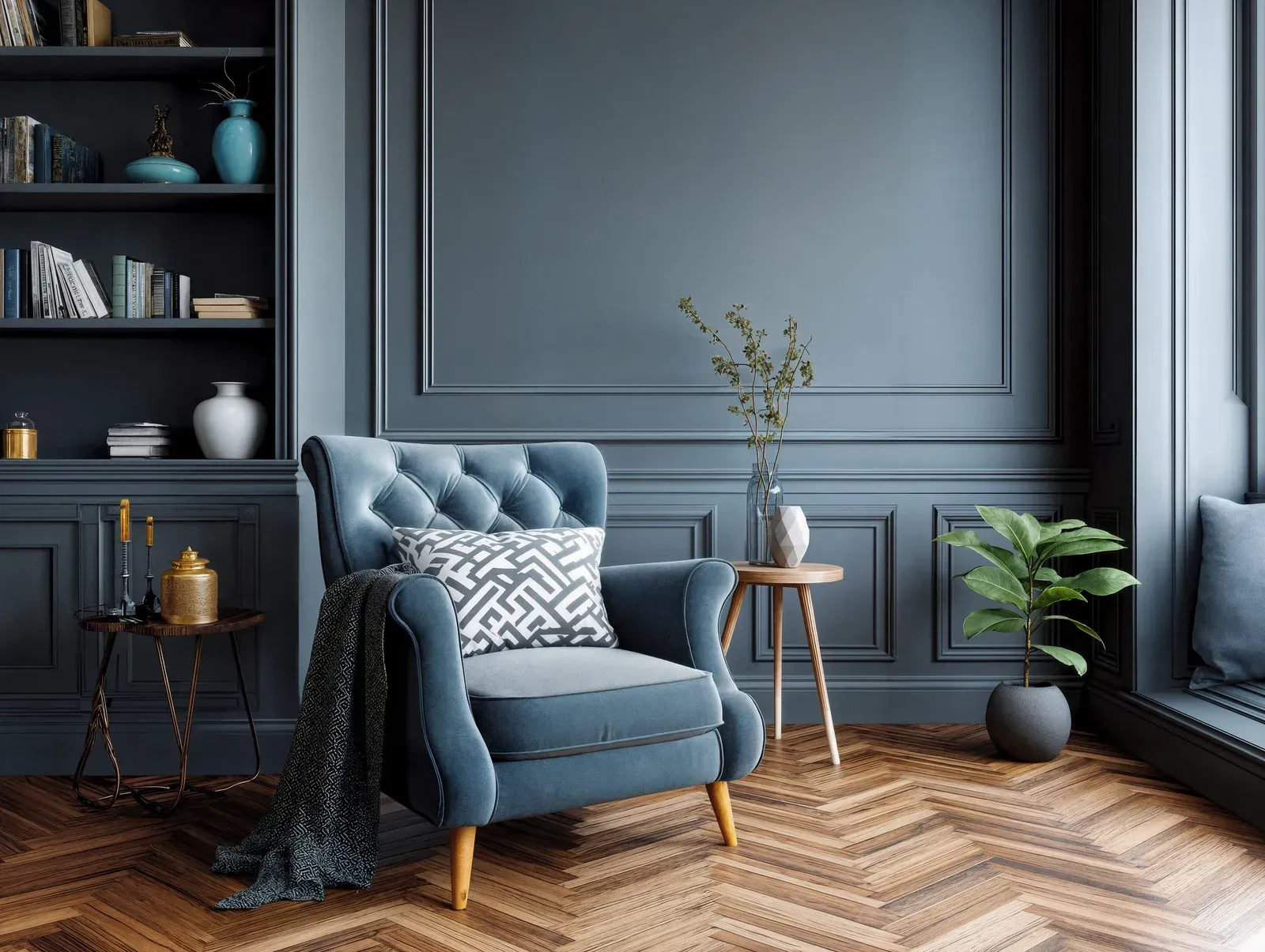 Blue armchair with blanket in a dark gray living room, beside shelves, side tables, and a potted plant.