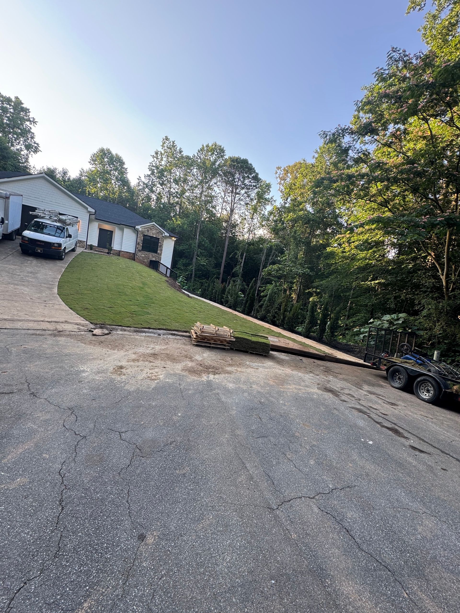 A car is parked on the side of the road in front of a house.