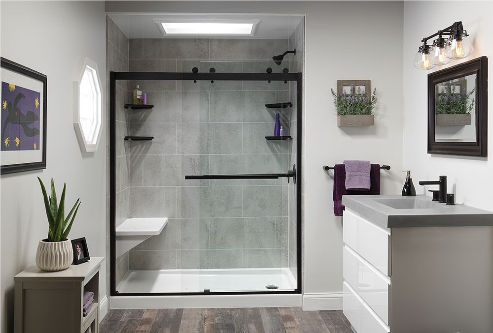 Modern bathroom with a glass shower, white vanity, and gray walls