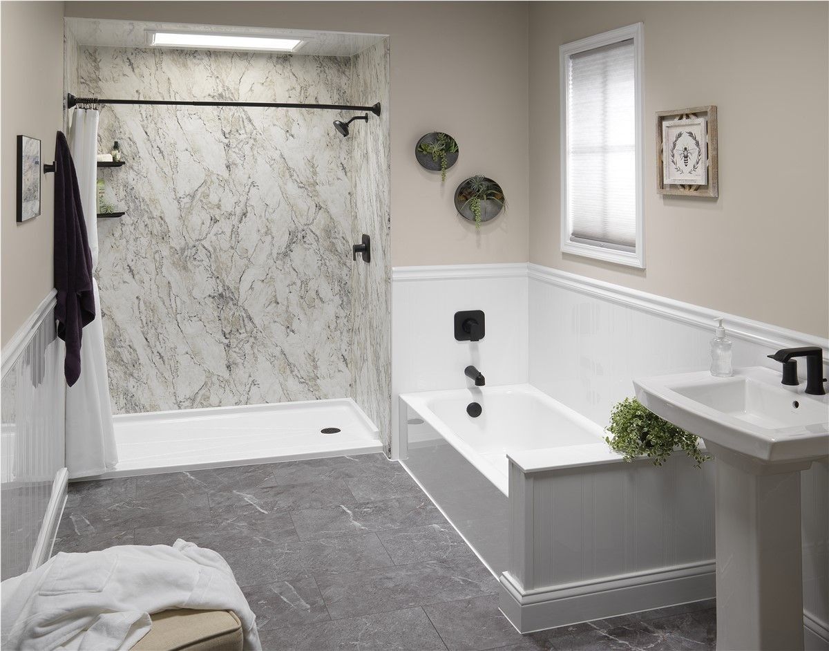 Accessible bathroom with walk-in marble shower, soaking tub, pedestal sink, and gray carpeted floor.