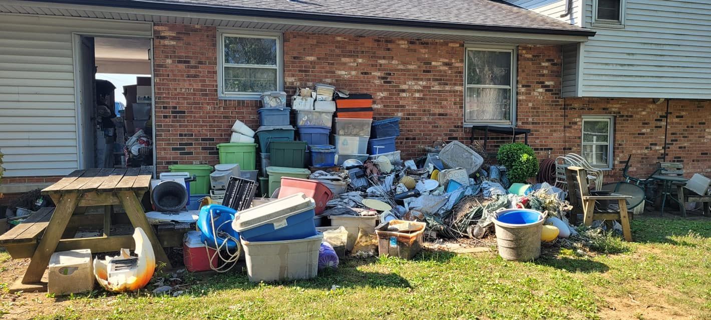 Residential yard with scattered yard waste and outdoor junk awaiting removal