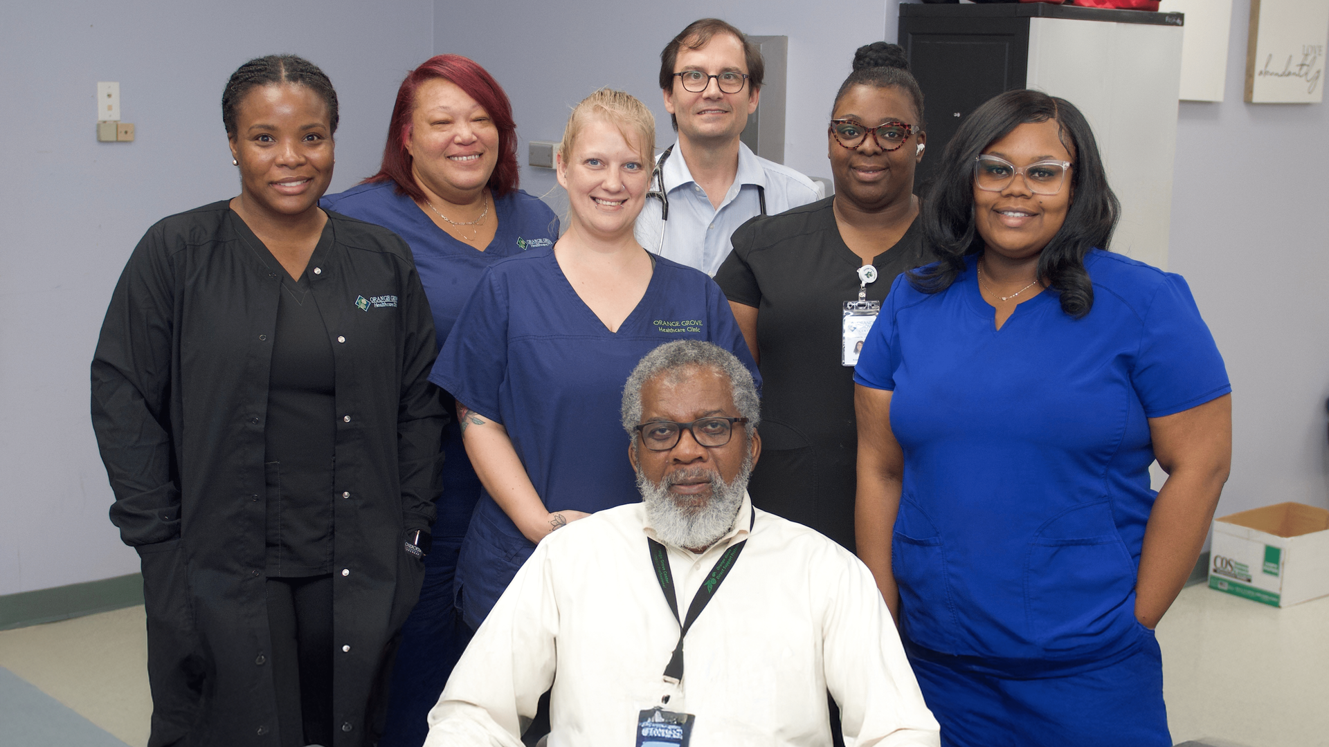 A group photo of seven members of Orange Grove's Clinical Services staff,  smiling and wearing scrubs.