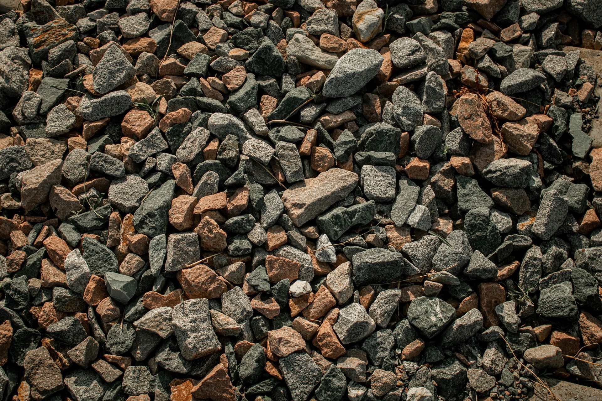 Pile of small brown and gray rocks or gravel filling the frame