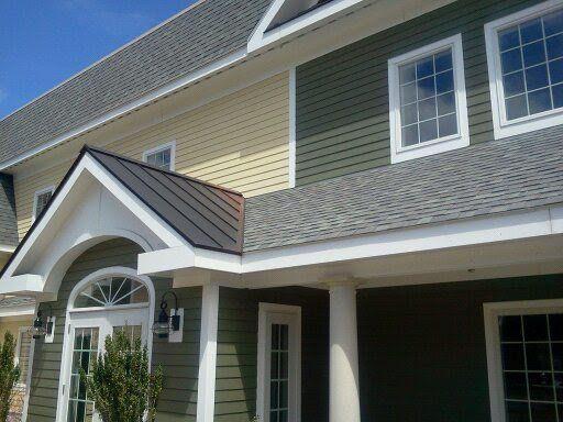 Suburban townhouse exterior with beige siding, gray roof, white trim, and a covered front entrance