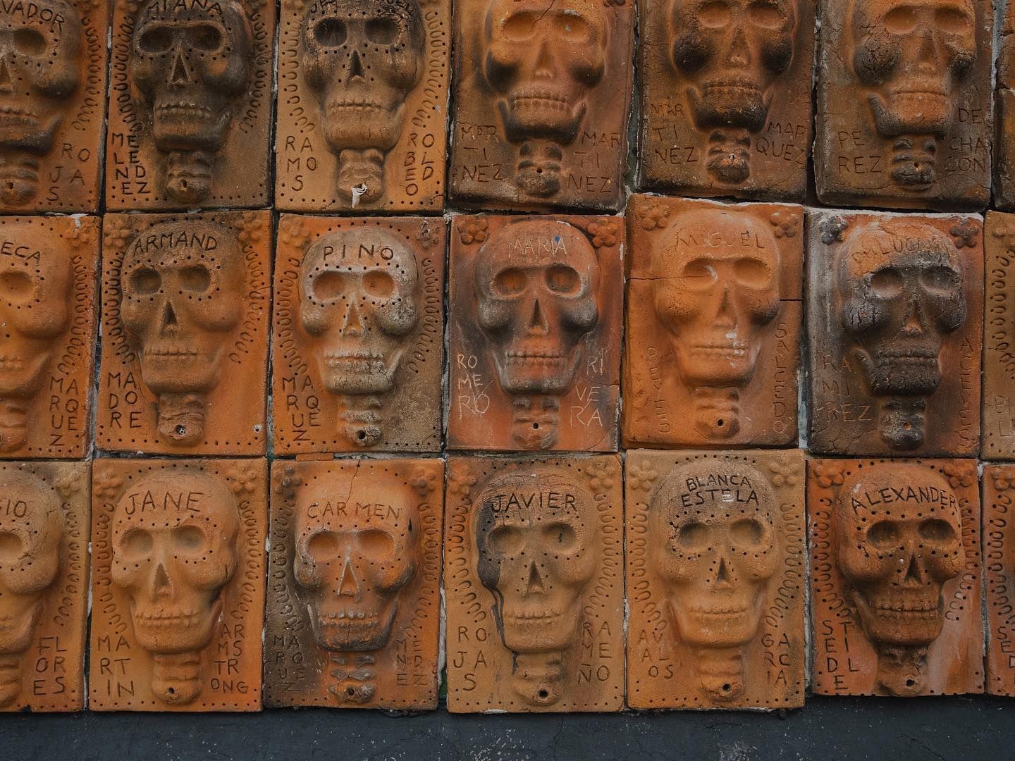 A row of bricks with skulls carved into them
