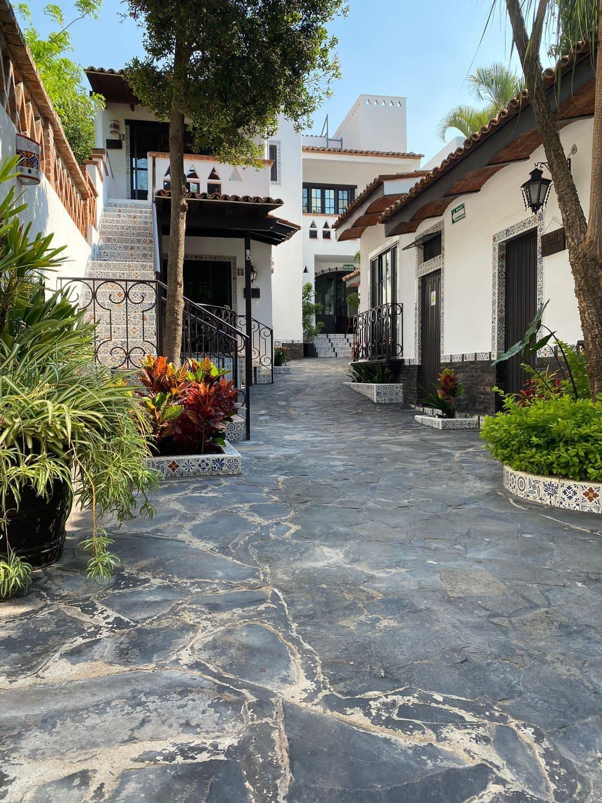A stone walkway leading to a white building