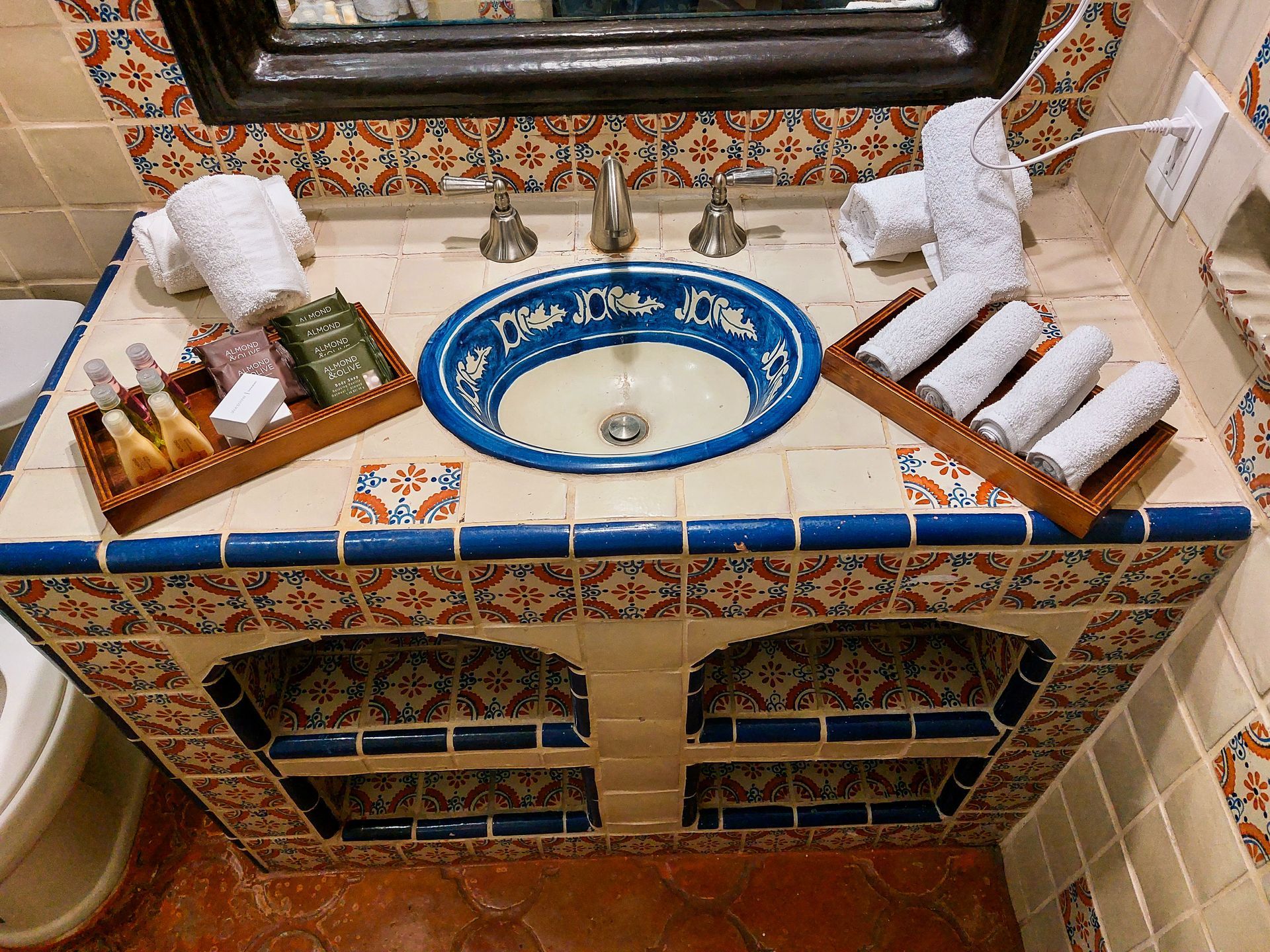 A bathroom counter with a sink and towels on it