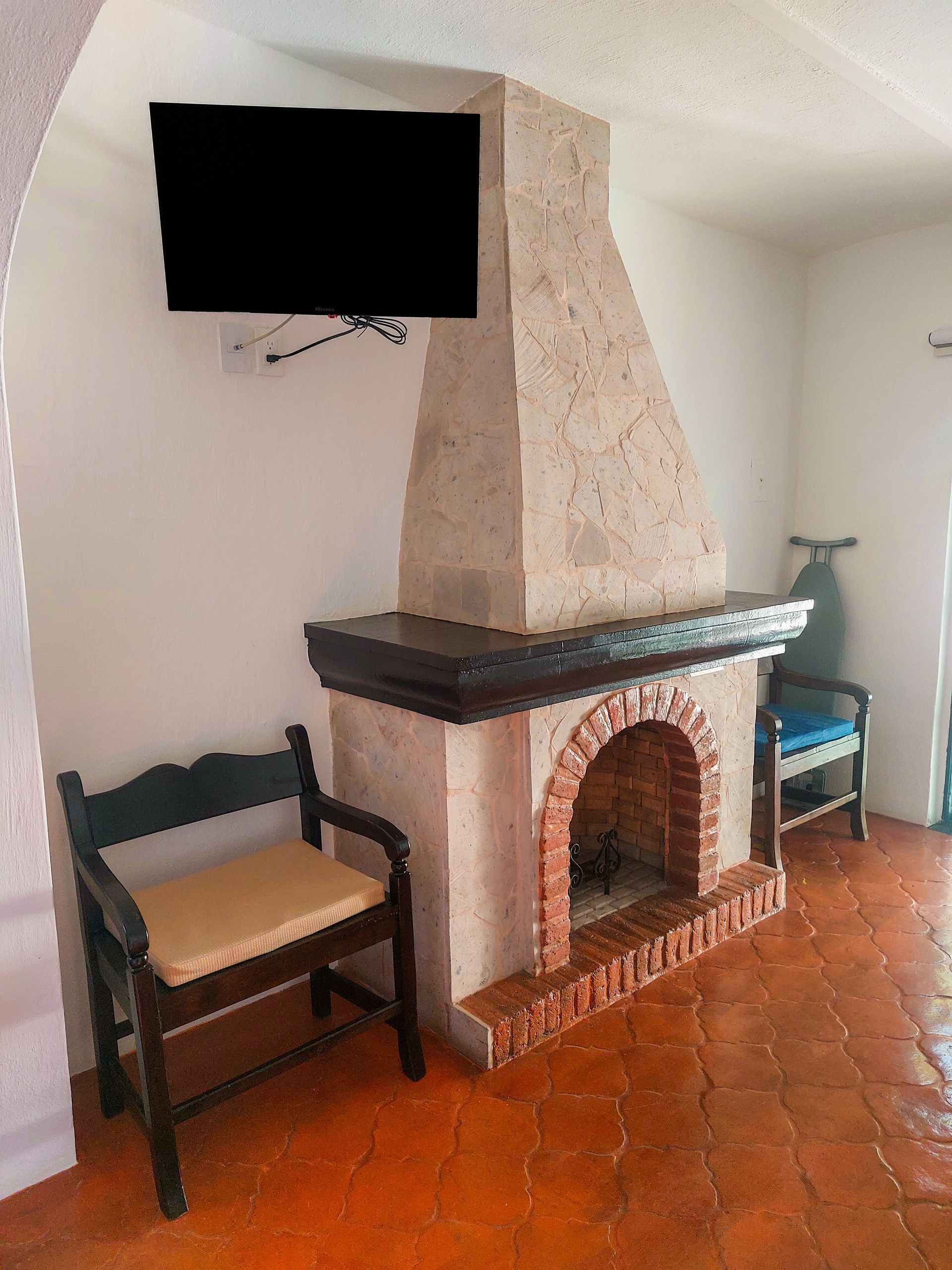 A living room with a fireplace and a flat screen tv