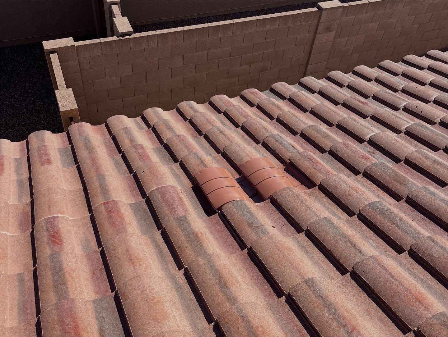 Terracotta tile roof with a section of replaced tiles.
