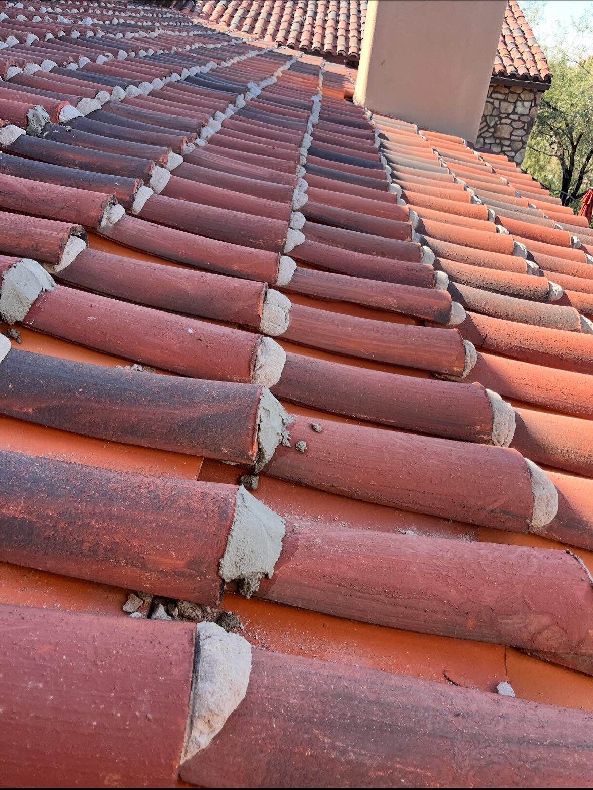 Red clay tile roof with mortar between tiles.