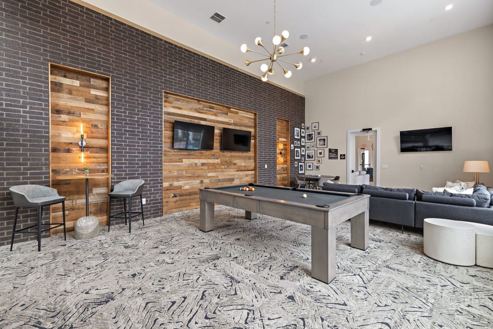 There is a pool table in the middle of the game room at The Avery, which offers apartments in North Austin, TX.