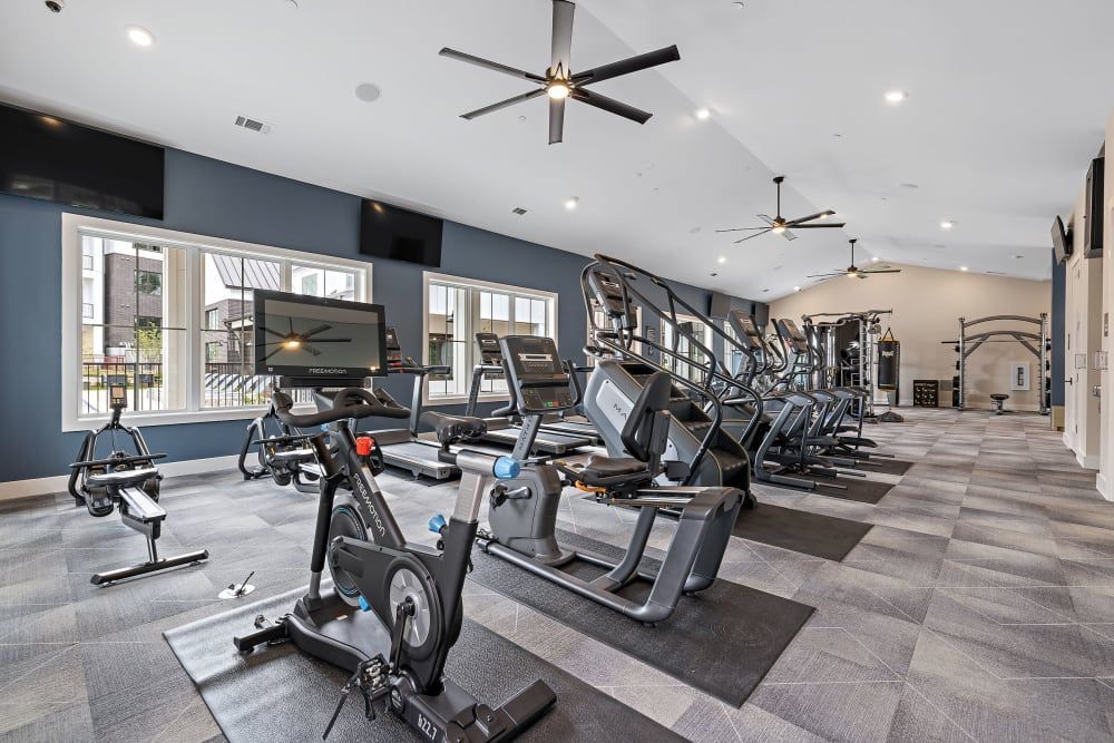 A large apartment building with a swimming pool and a fire pit in front of it at The Avery, which offers apartments for rent in Brushy Creek, Austin, TX.
