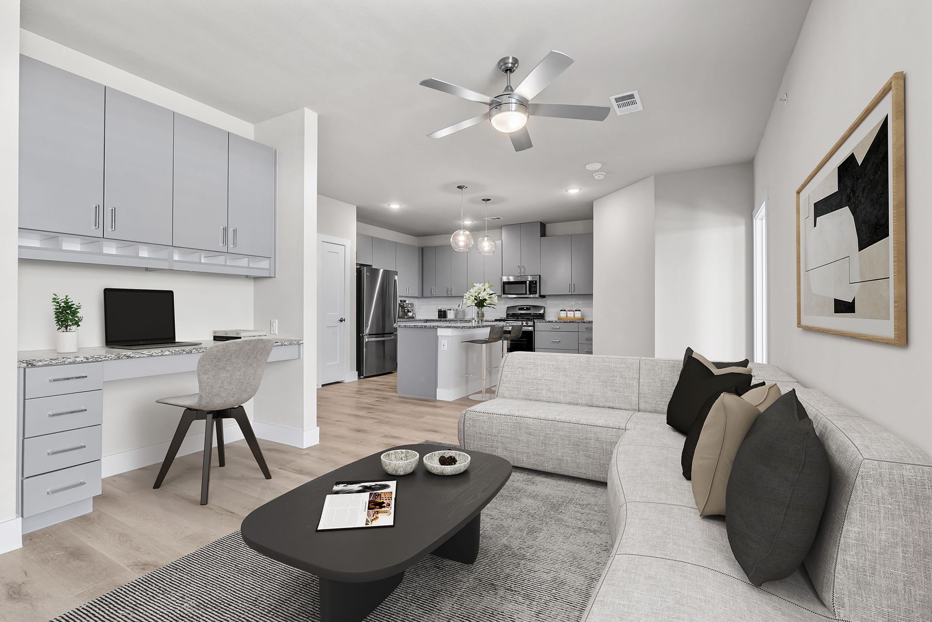 A living room with a couch, coffee table, television, and ceiling fan at The Avery, offers apartments for rent in Brushy Creek, Austin, TX.