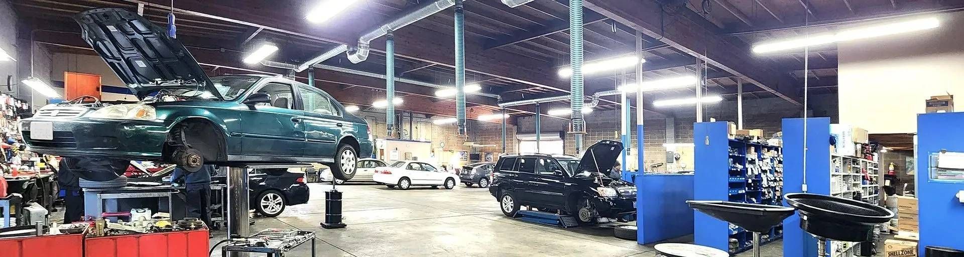 Mechanics working on cars at our auto repair shop | Berkeley Minicar