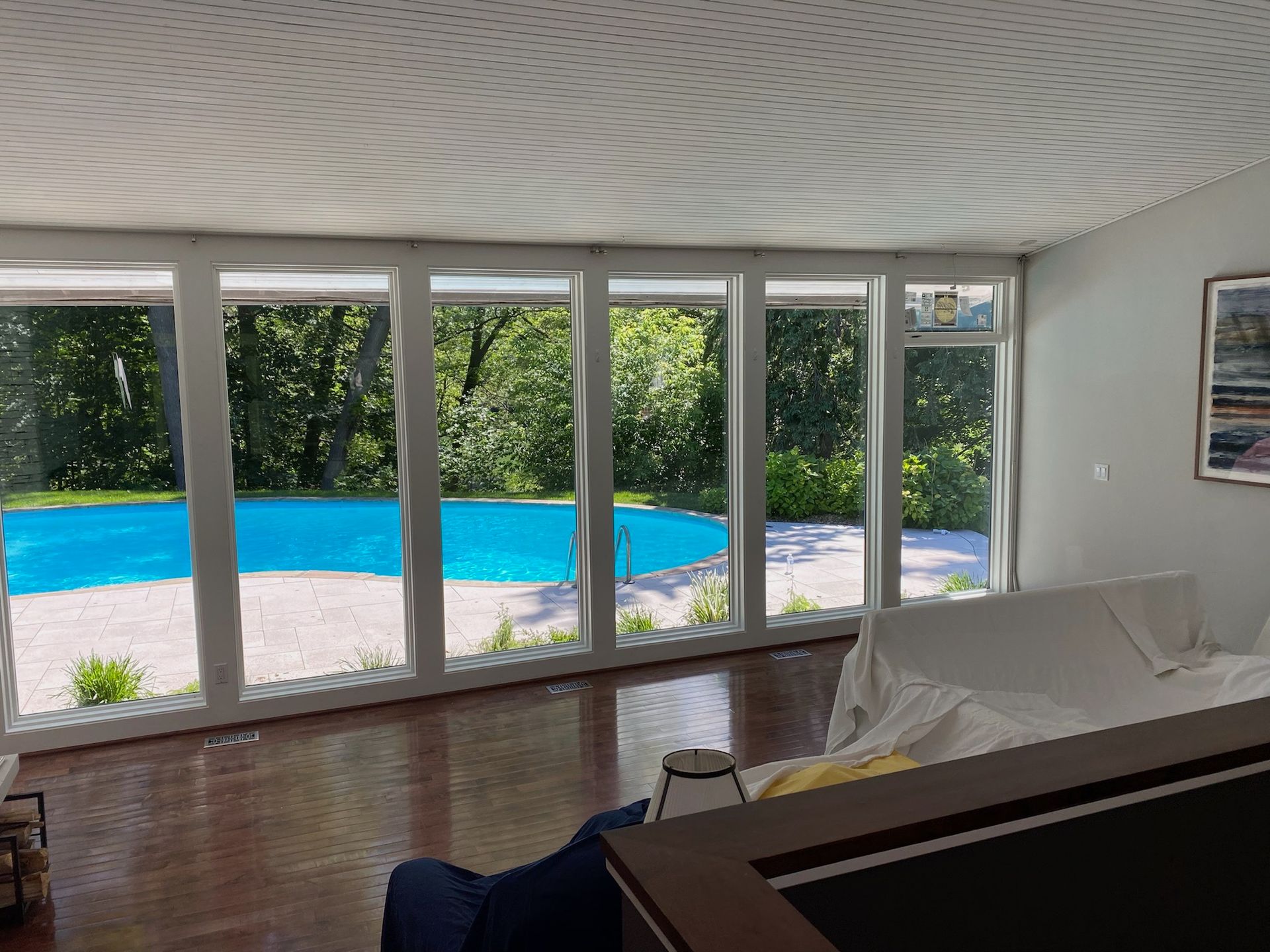 Interior view with pool visible through large windows.