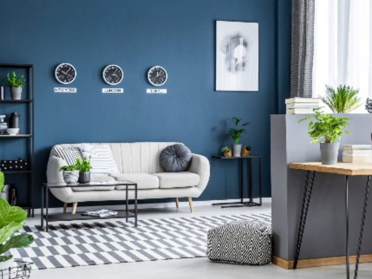 A living room with blue walls and a white couch