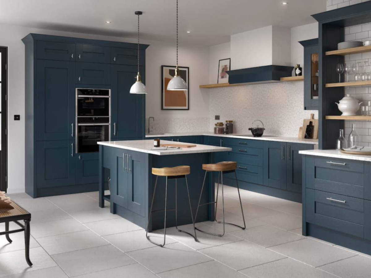 A kitchen with blue cabinets and white counter tops