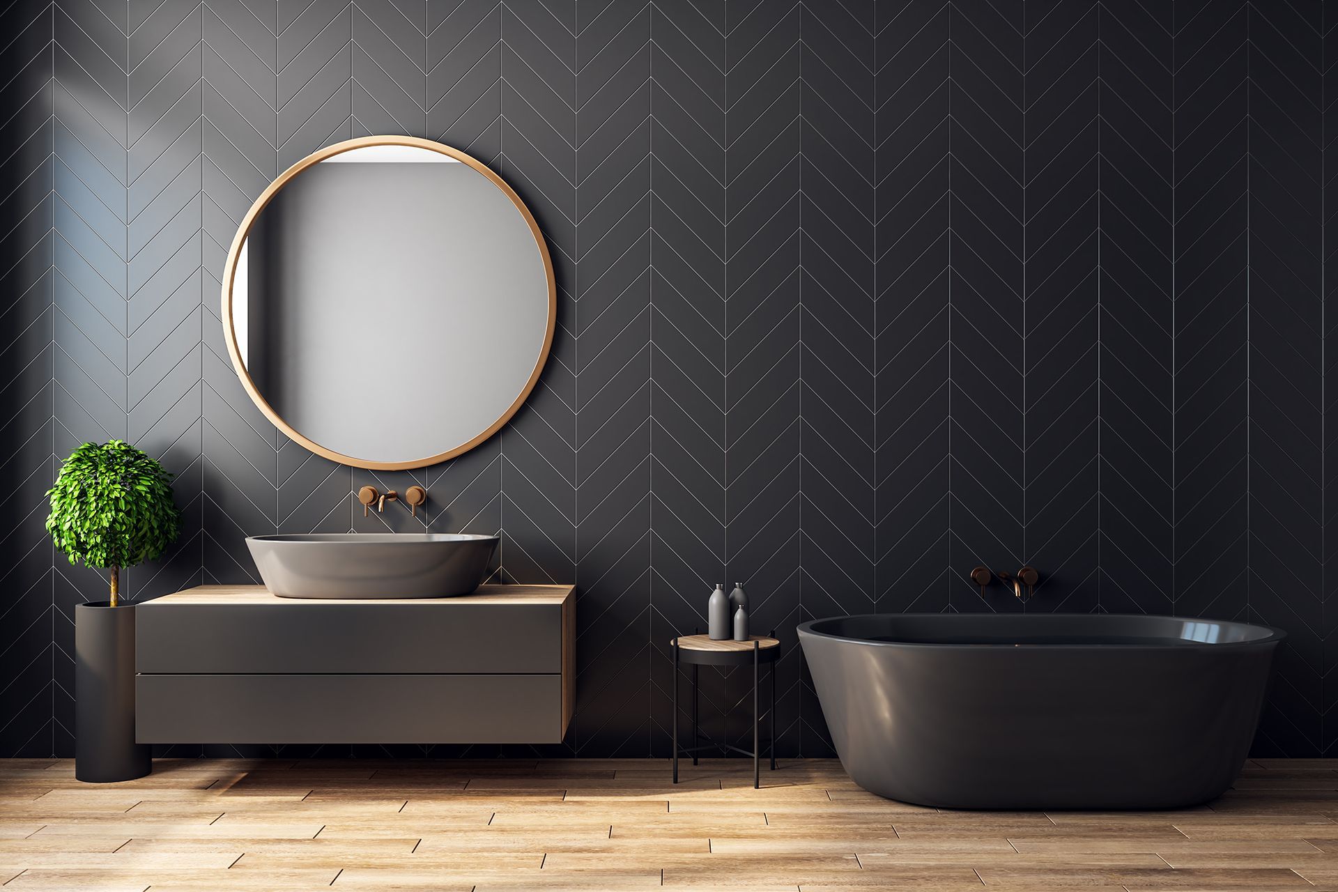 A bathroom with black tiles , a sink , a bathtub and a mirror.