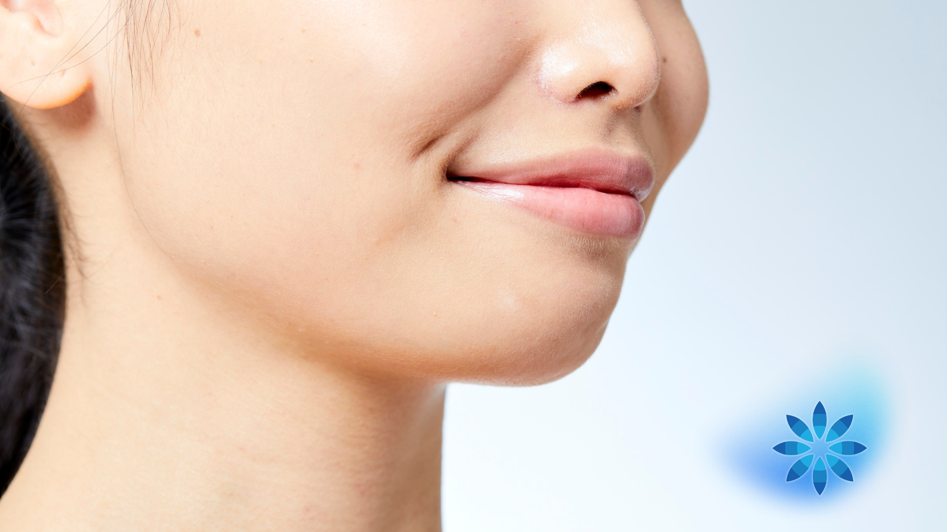 A person's side profile, smiling slightly, with a blue snowflake graphic.