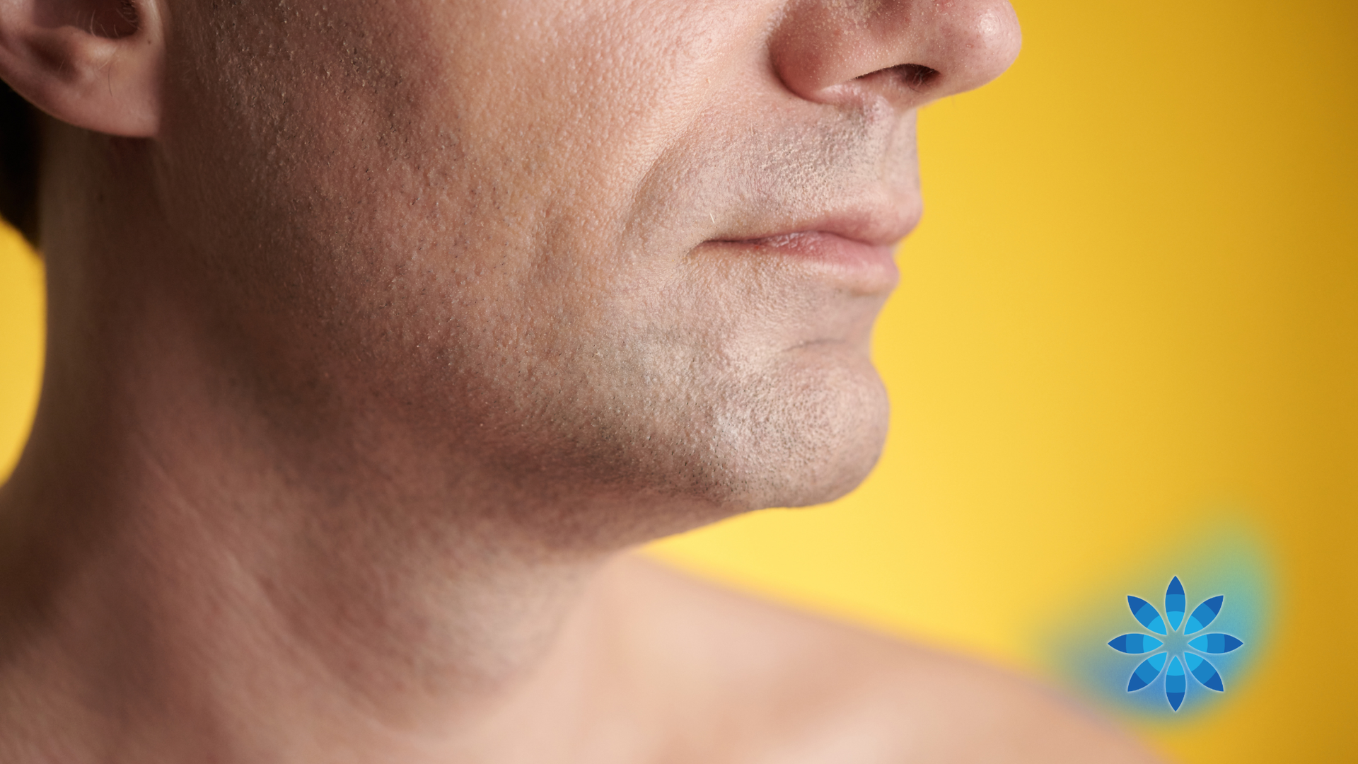 Close-up of a person's jawline and neck against a yellow background.