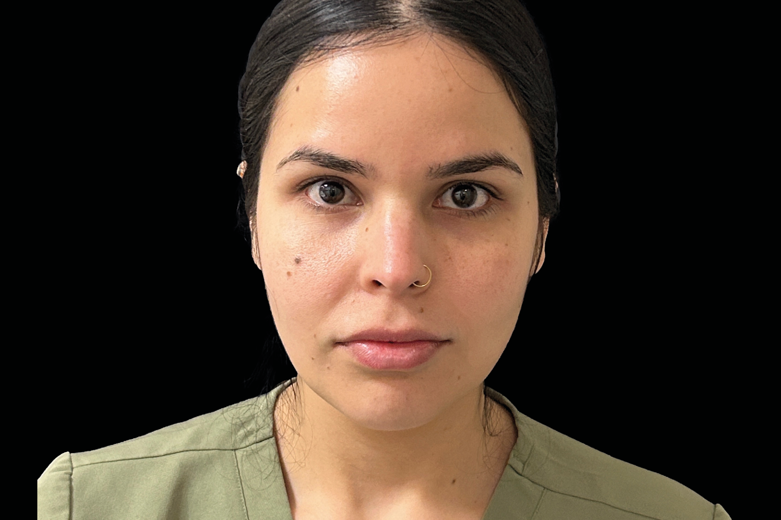 Portrait of a woman against a black background, facing forward with a neutral expression.