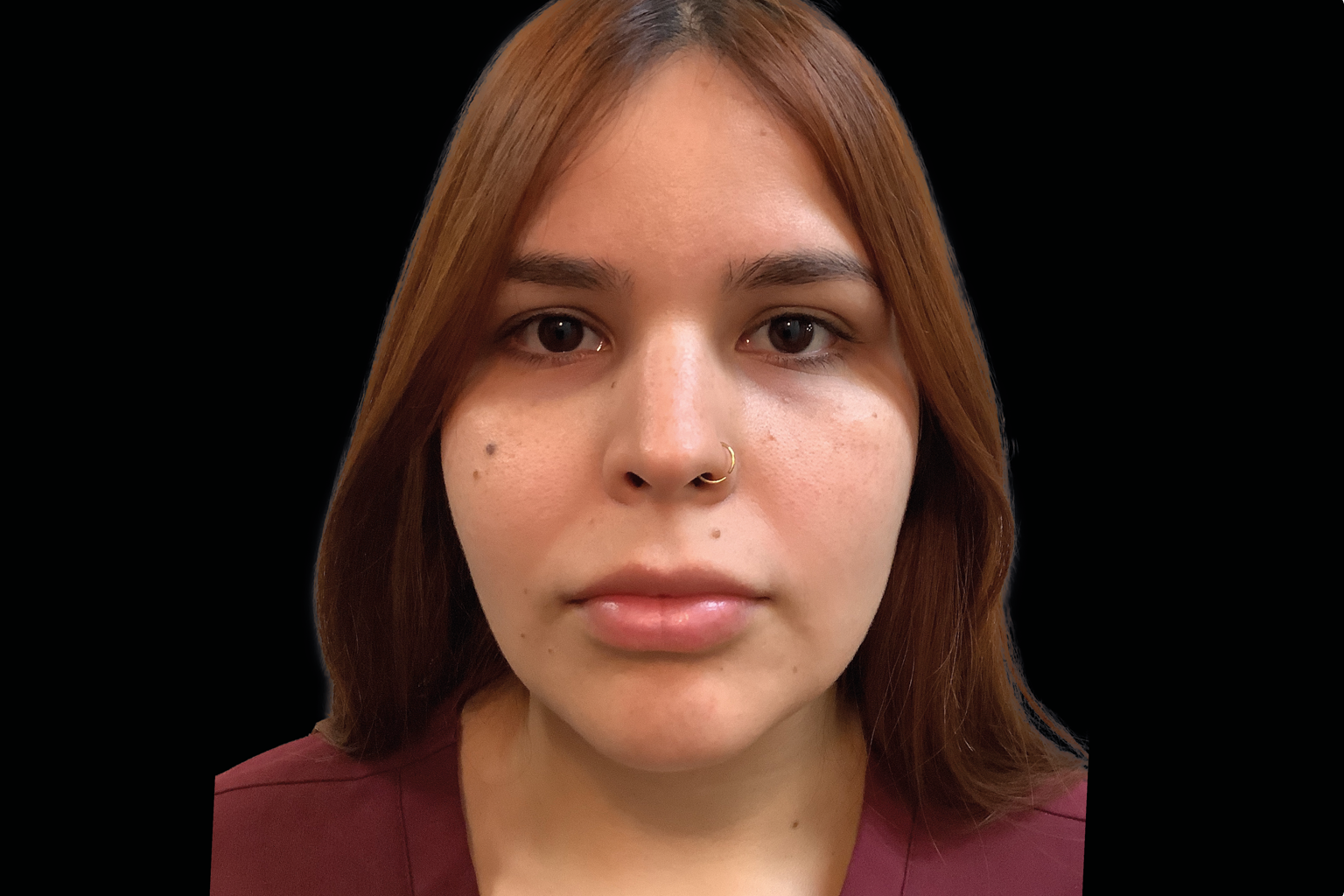 Front-facing portrait of a person with brown hair and a nose ring against a black background