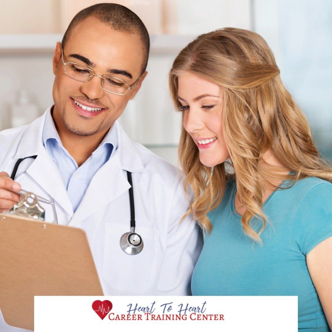 Doctor reviewing paperwork with a patient; both are smiling in a medical setting.