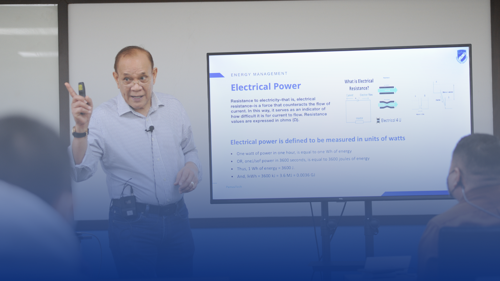 A man is giving a presentation in front of a group of people.