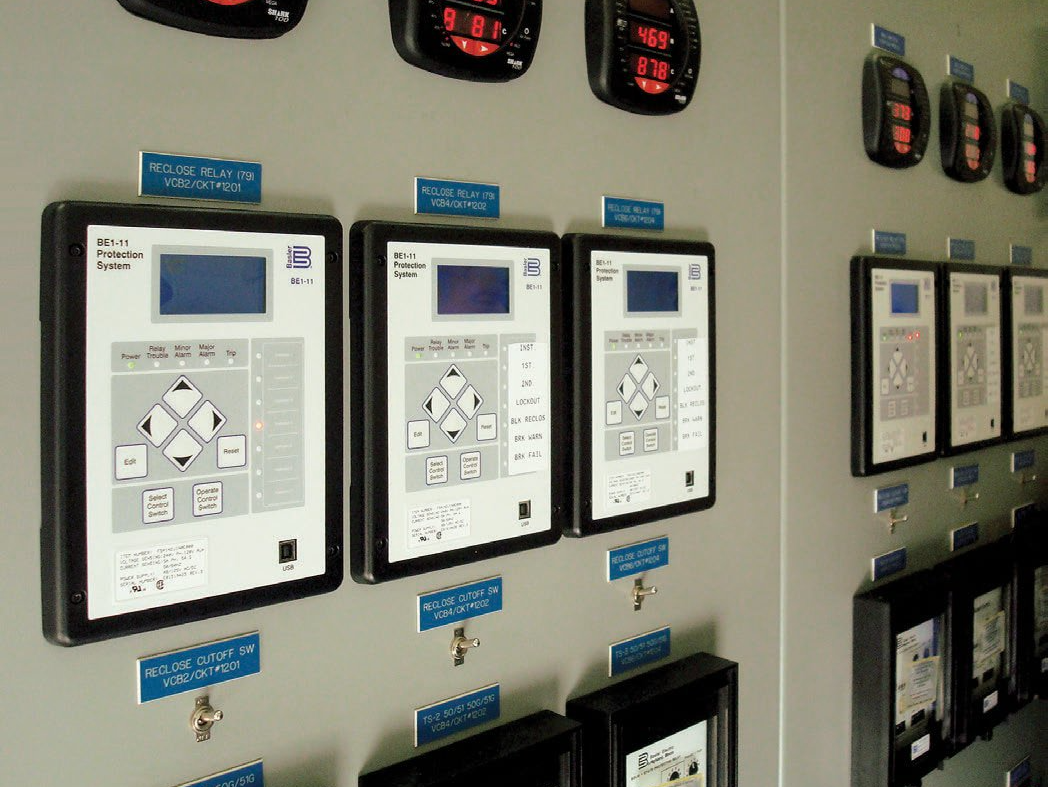 A wall with a bunch of control panels on it