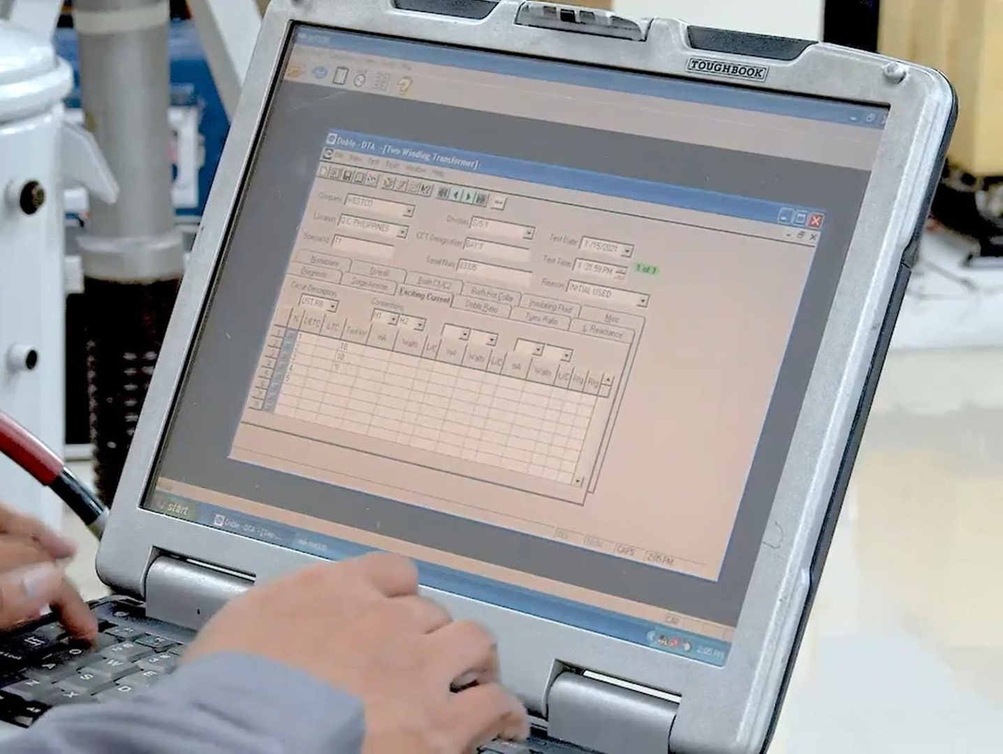 A person is typing on a laptop that says ' sharp ' on it