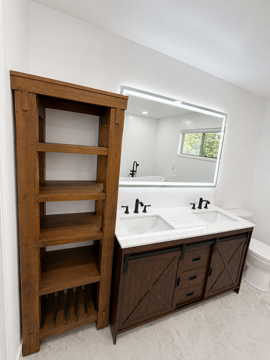 Bathroom vanity with double sinks, white countertop and mirror, and a wooden open shelving unit beside it