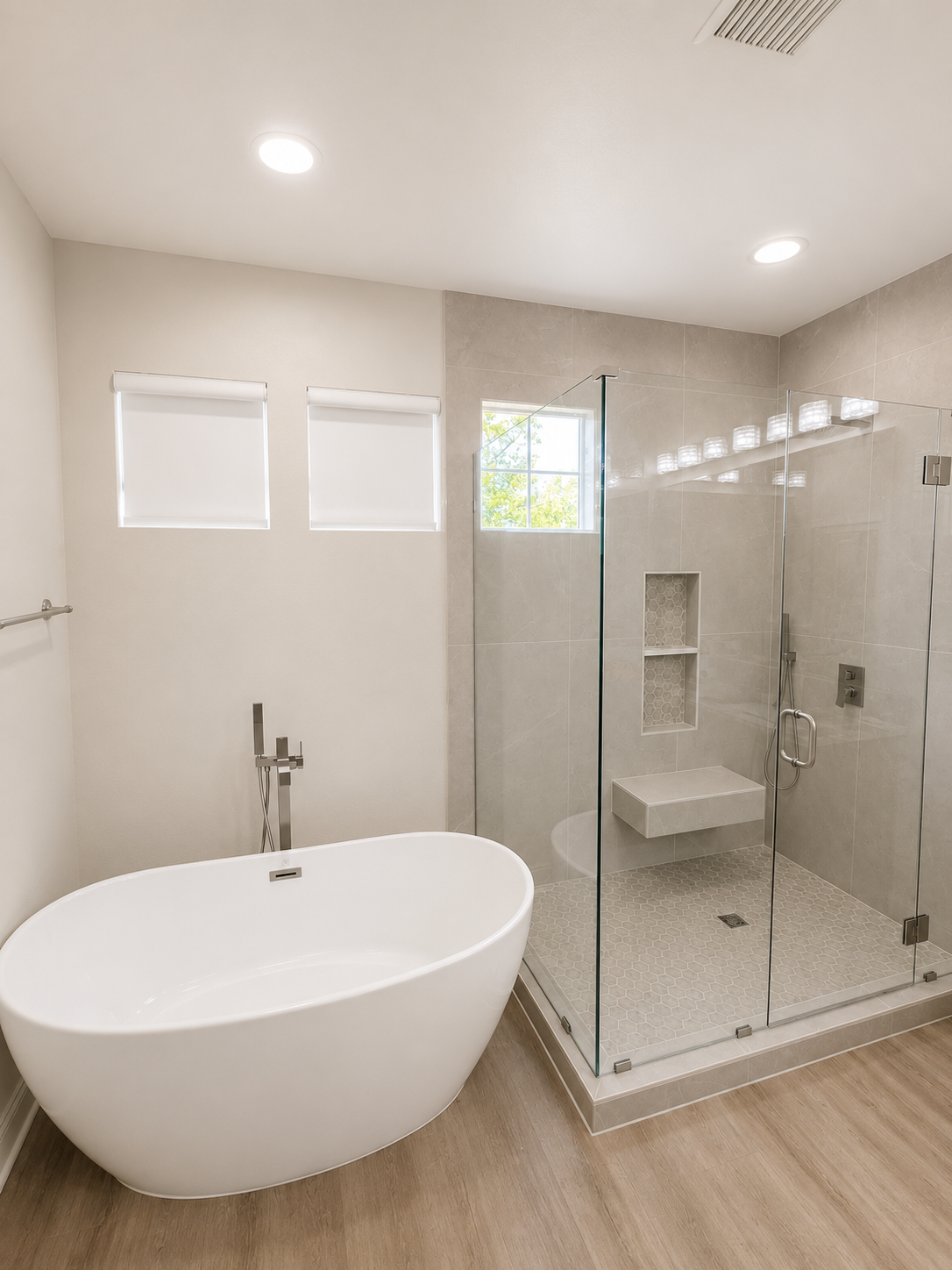 Modern bathroom with freestanding tub, glass shower, and light wood flooring