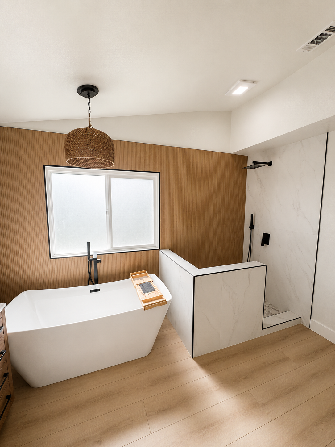 Modern bathroom with white tub, wood wall paneling, window, and pendant light