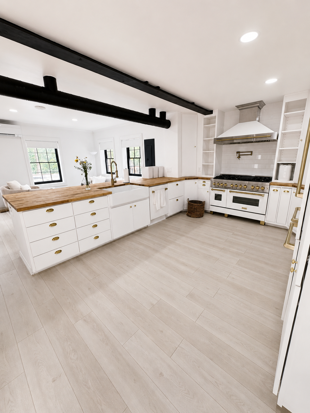 Bright white kitchen with wood countertops, black beams, and a stove under a range hood