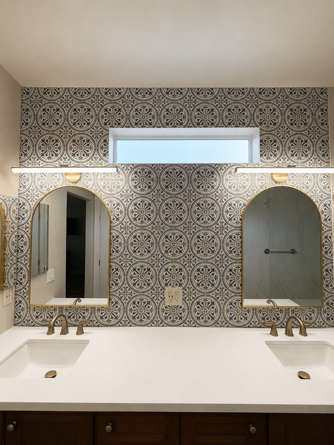 Bathroom vanity with two mirrors, white countertop, and patterned tile backsplash