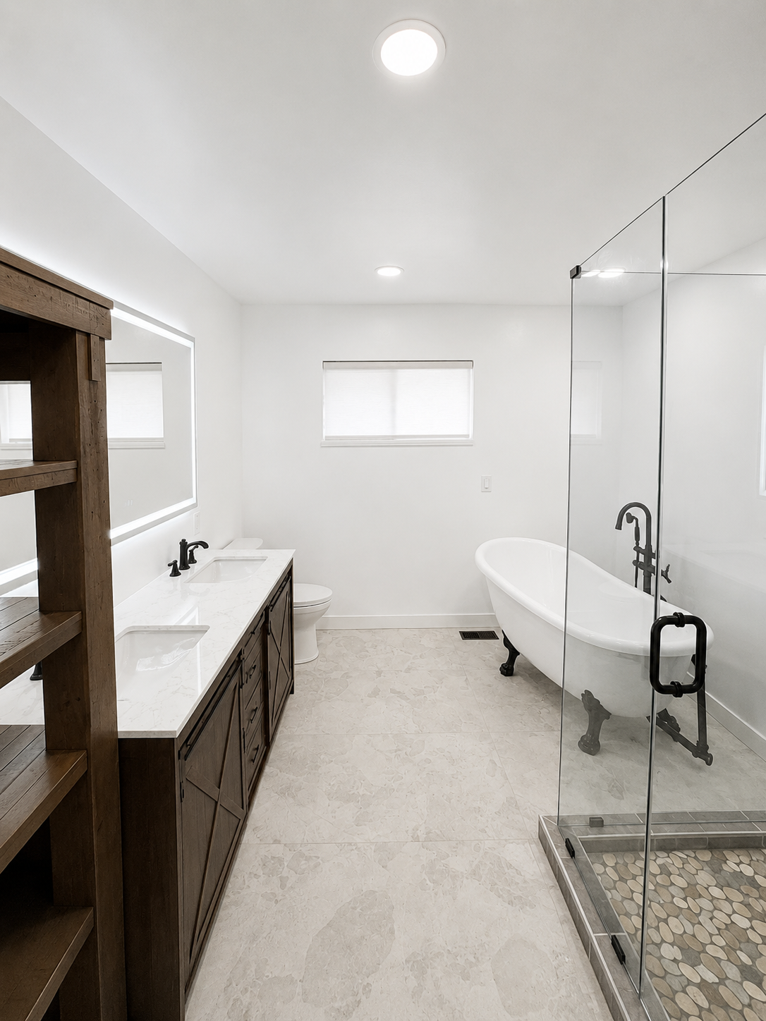 Modern bathroom with double vanity, freestanding tub, glass shower, and bright white finishes